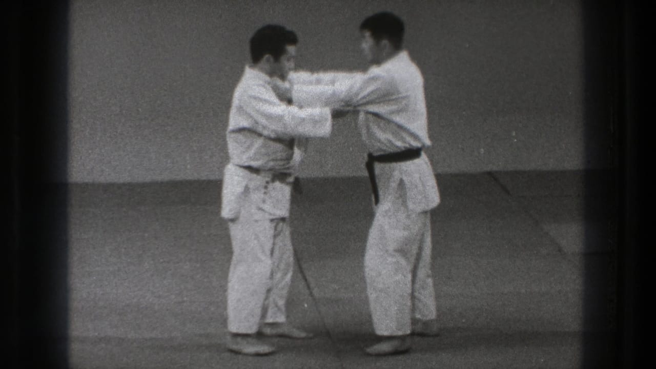 The 1971 Tokyo home-movie frame shows the pair holding gi grips and adjusting balance during the throwing-technique setup.