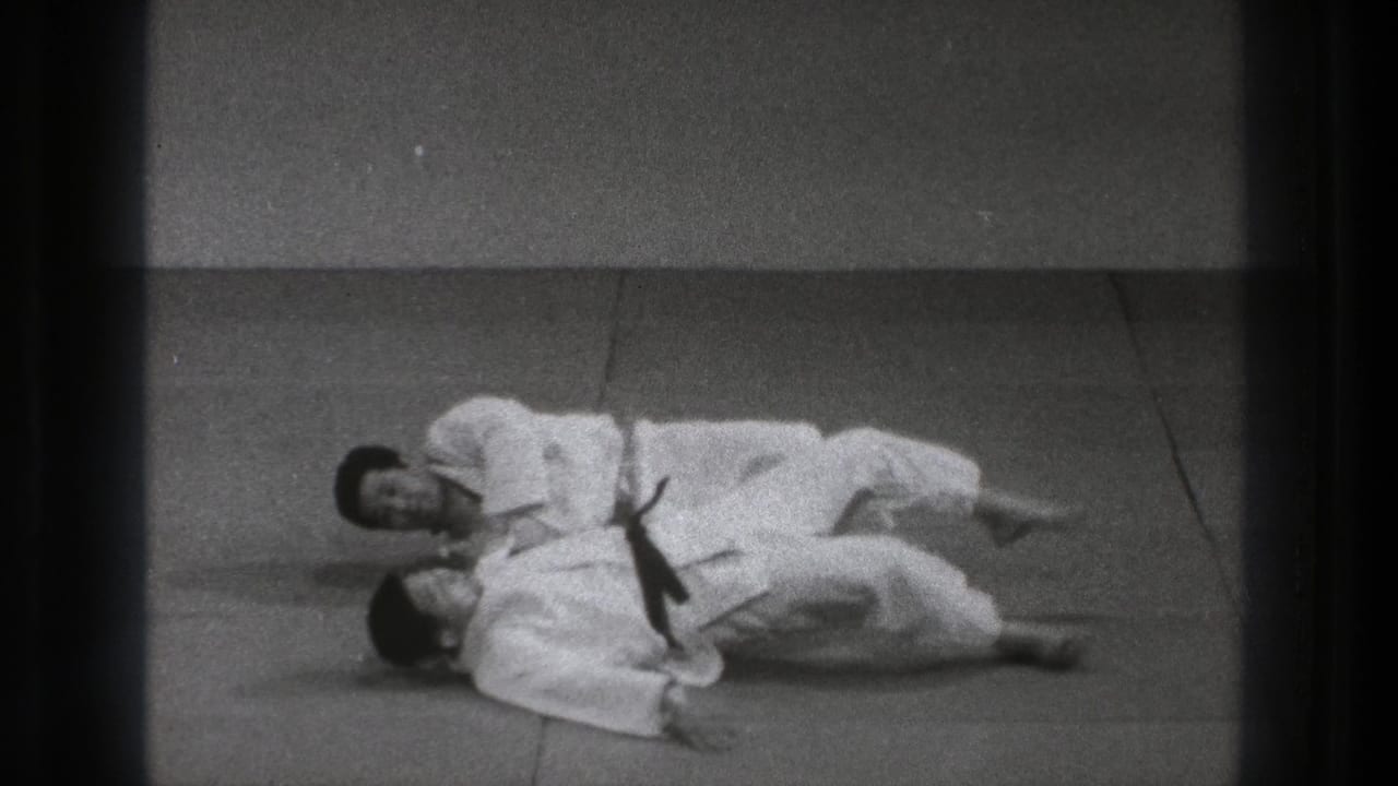 The 1971 Tokyo martial arts practice shows both practitioners on the mat after a controlled judo throw or takedown.