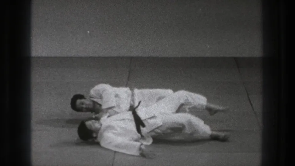 The 1971 Tokyo martial arts practice shows both practitioners on the mat after a controlled judo throw or takedown.
