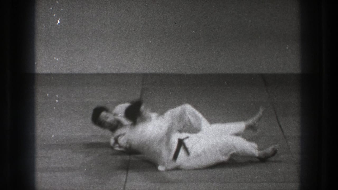 After the throw in this Tokyo 1971 judo footage, both practitioners are on the mat with one controlling the landing position.