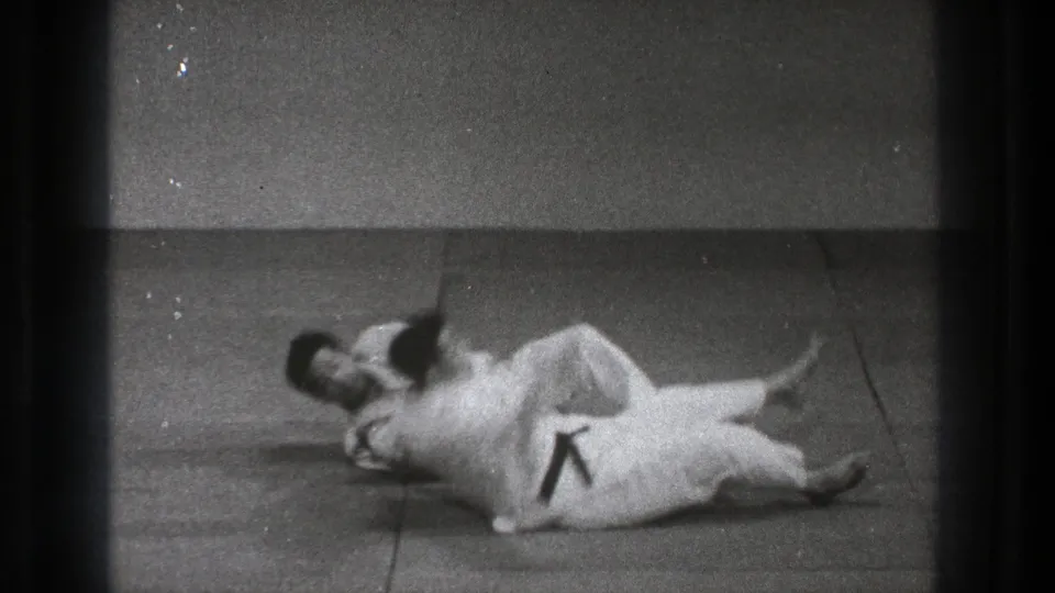 After the throw in this Tokyo 1971 judo footage, both practitioners are on the mat with one controlling the landing position.