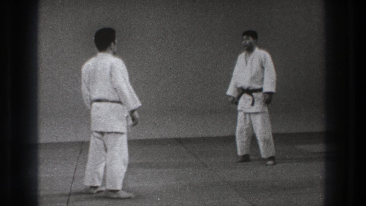 1971 Tokyo 8mm frame of two adult martial artists in gi standing apart before resuming practice.