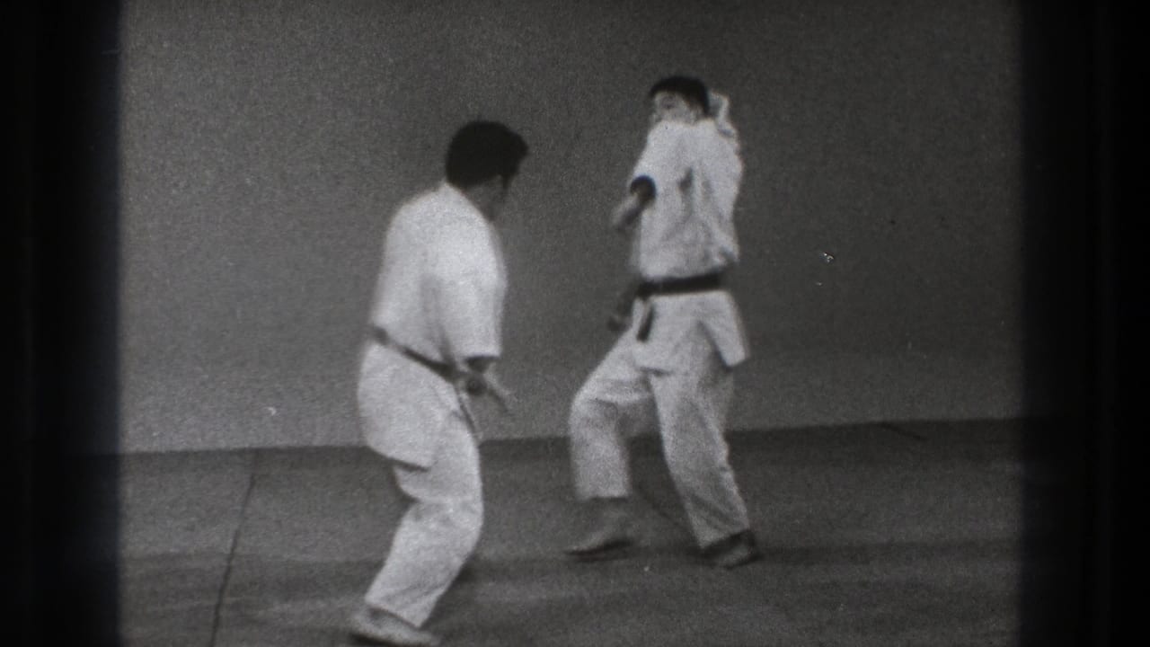1971 Tokyo 8mm frame showing two martial artists in white gi preparing for another judo-style exchange.