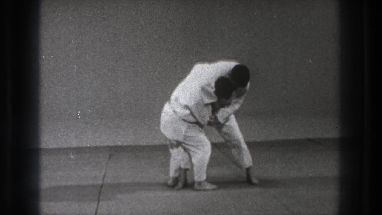 Near the end of the Tokyo 1971 clip, the practitioners stay locked in a compact throw position on the mat.