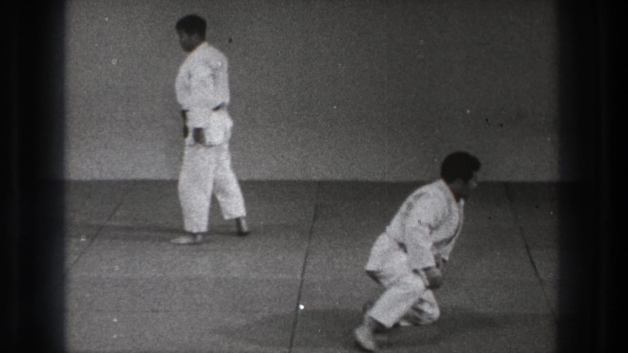 The final frame shows one man standing in a white uniform as another kneels or rises on the mat during 1971 Tokyo martial arts practice.