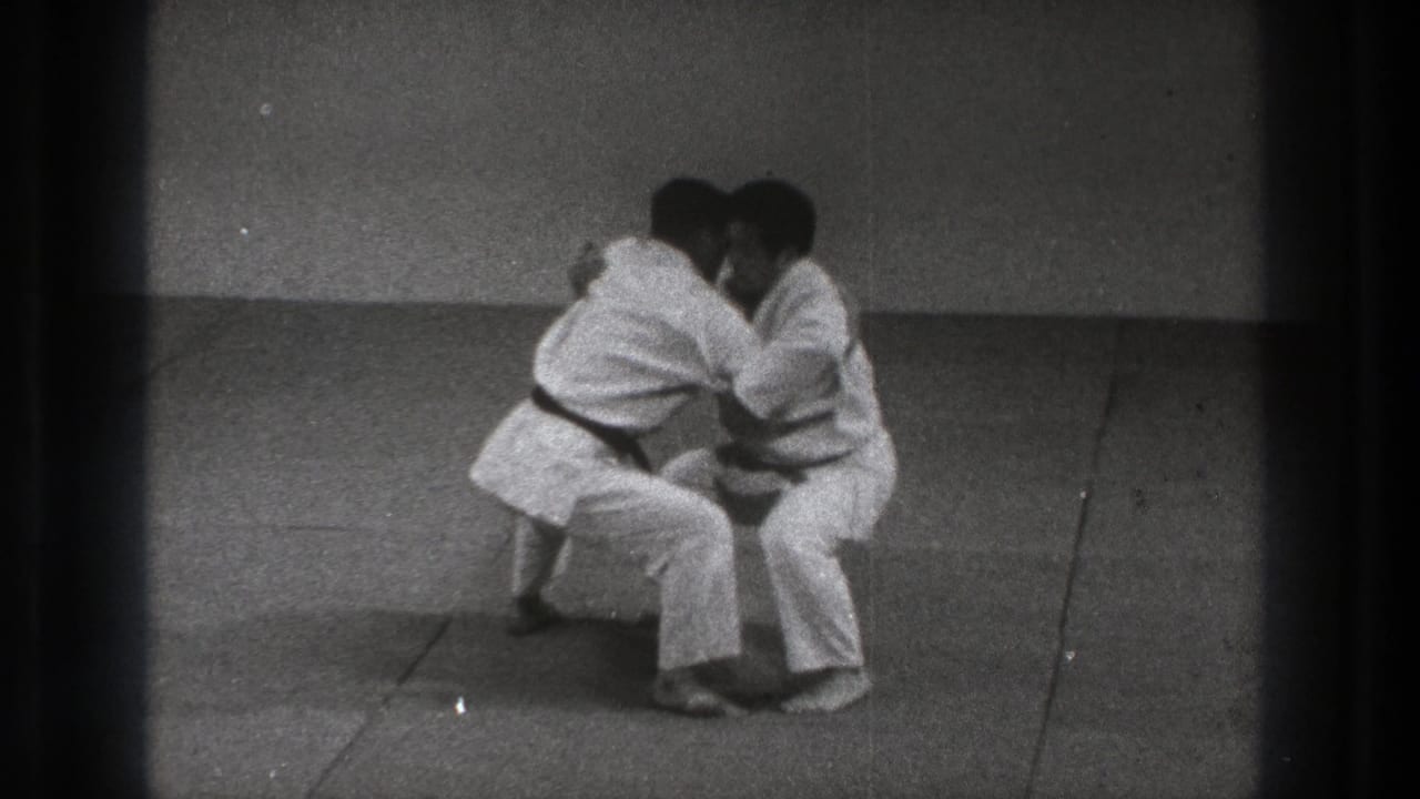 The Uki Waza practice continues with both men crouched low and joined at the upper body in the 1971 Tokyo 8mm footage.