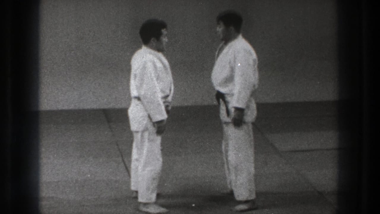 1971 Tokyo frame showing two adult martial arts practitioners facing each other before engaging again.