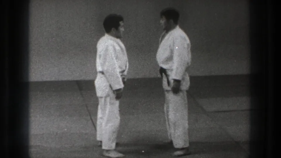 1971 Tokyo frame showing two adult martial arts practitioners facing each other before engaging again.