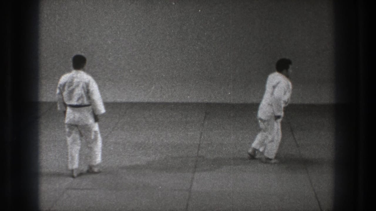 Near the end of the Tokyo 1971 practice clip, both men in white gi are upright on the mat after the throw and recovery movement.