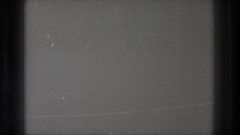 1971 Tokyo 8mm frame of a filmed television-like no-signal screen with a horizontal line, dark borders and analog grain.