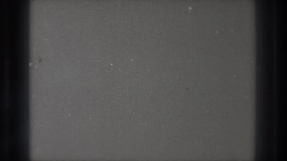 Cataloged Tokyo 1971 8mm frame returning to a blank dark field with visible grain, dust, and gate shadowing.