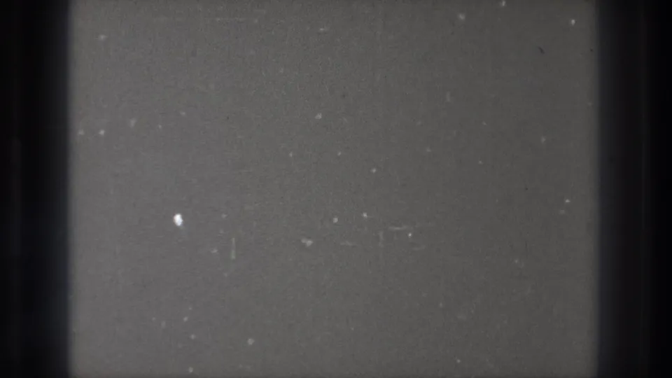 1971 Tokyo 8mm blank-frame texture with heavy dark vertical borders, scattered dust, and faint surface marks.