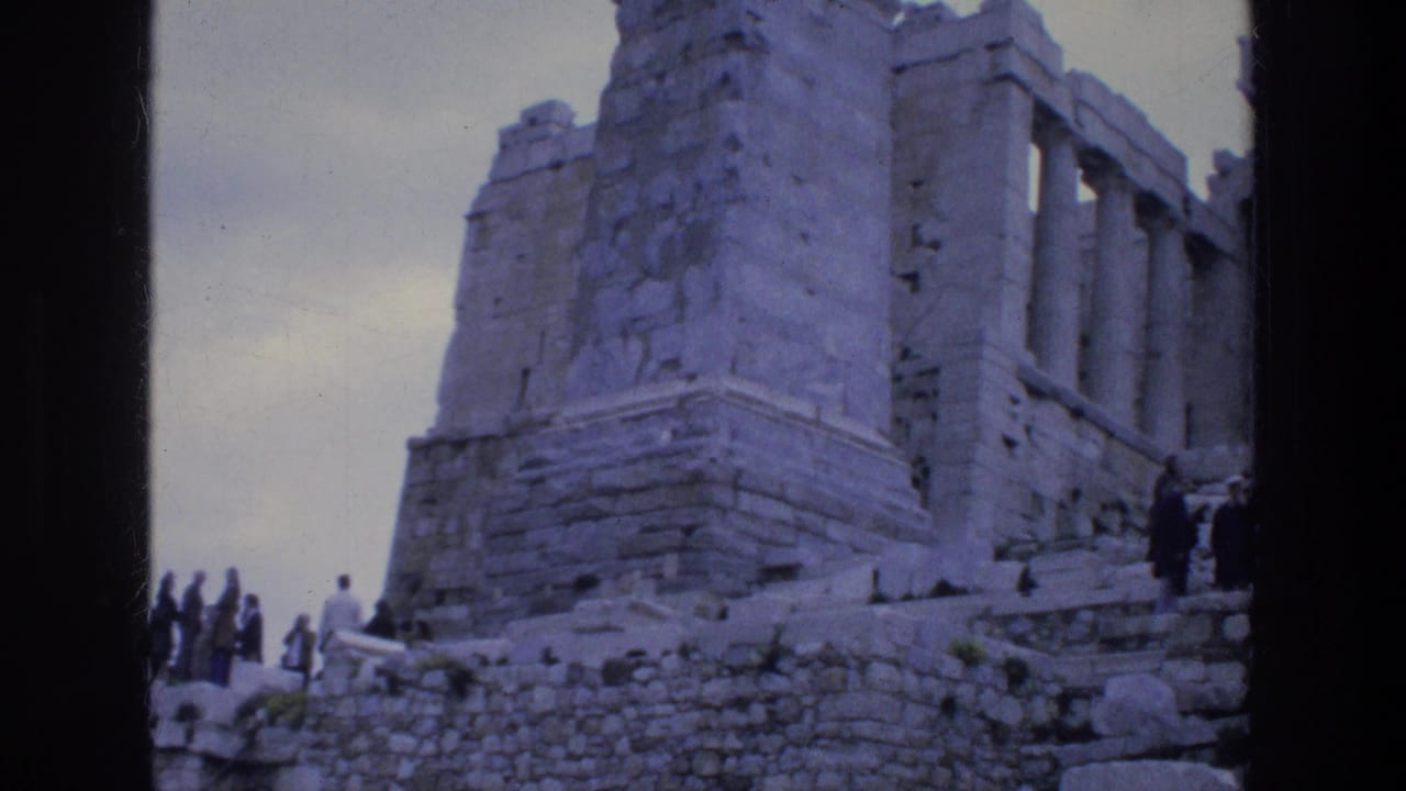 Tourists at the Acropolis in Athens, seen near weathered stone walls and column remains on faded 1970s 8mm film.