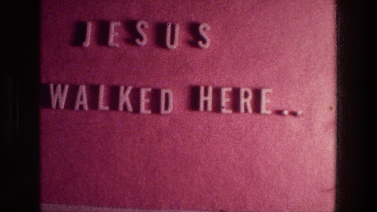 Reddish plaque with raised letters reading Jesus walked here.