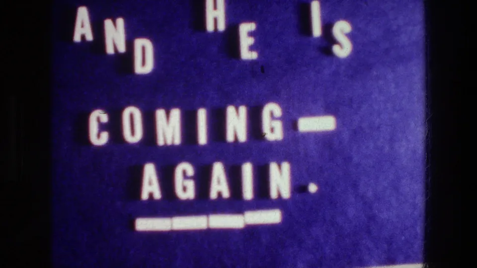 The filmed title card remains static, with white letters and underline bars visible against a purple field.