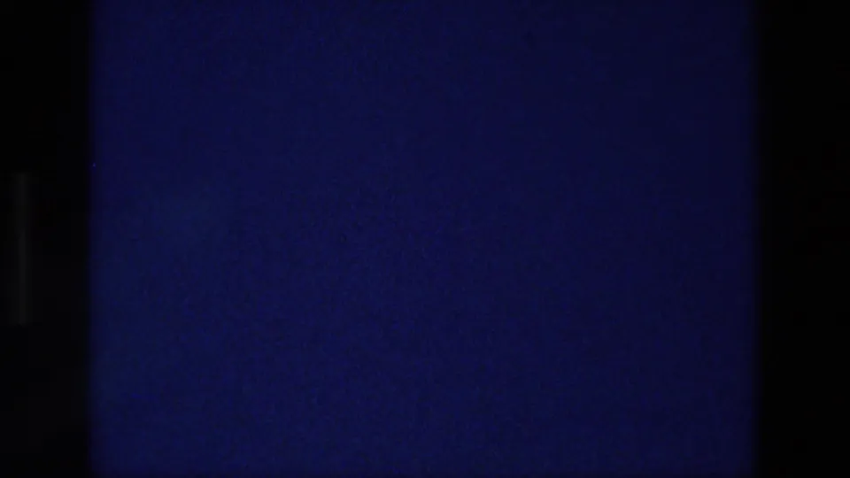 The clip cuts to a dark blue-black frame, suggesting a transition or end of the filmed title card.