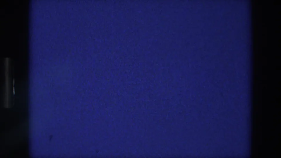 Blue 8mm frame with a central dark bar, side border, visible grain, and no people or text.