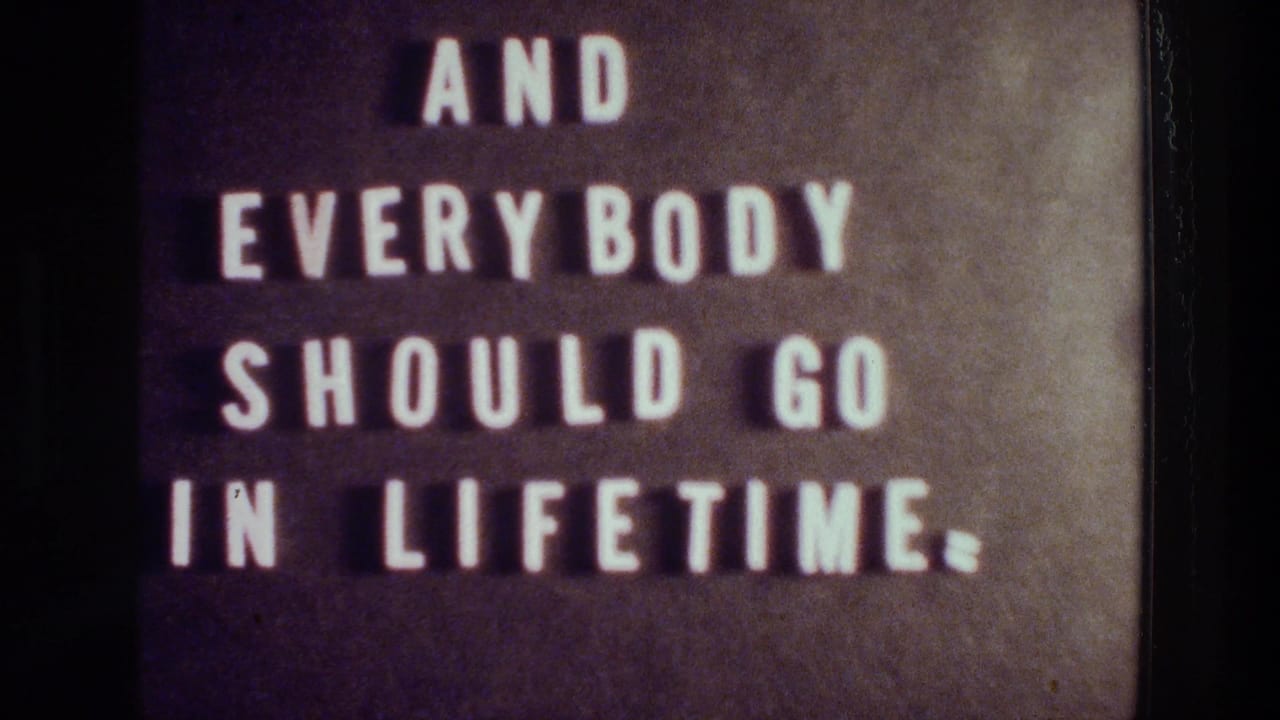 Dark sign with white letters reading “AND EVERYBODY SHOULD GO IN LIFETIME.”