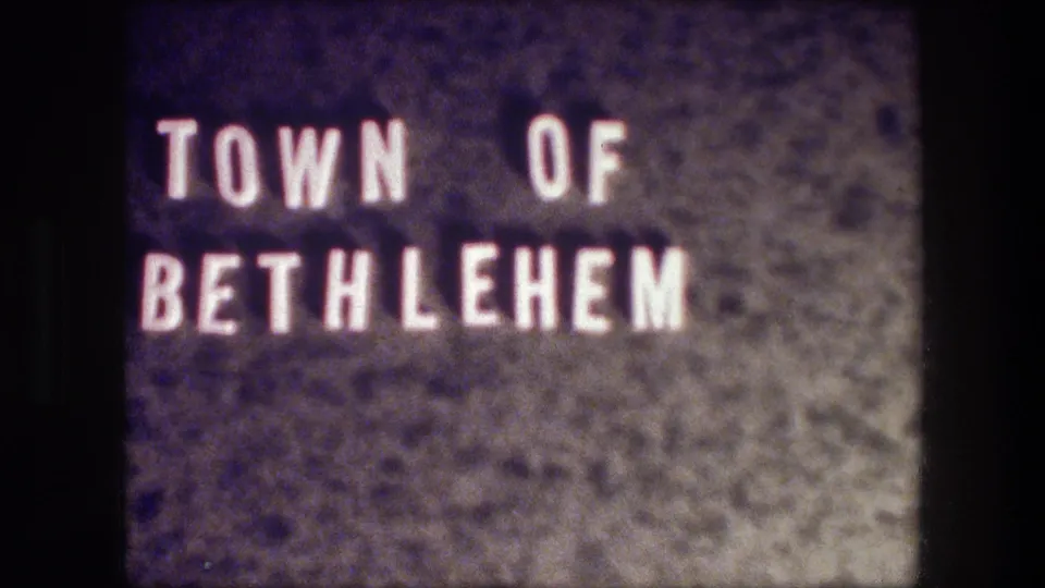1976 8mm Bethlehem travel title card with white block lettering reading Town of Bethlehem against a dark textured background.