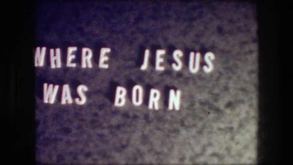 Second view of the title message 'WHERE JESUS WAS BORN' before the Bethlehem street scene.
