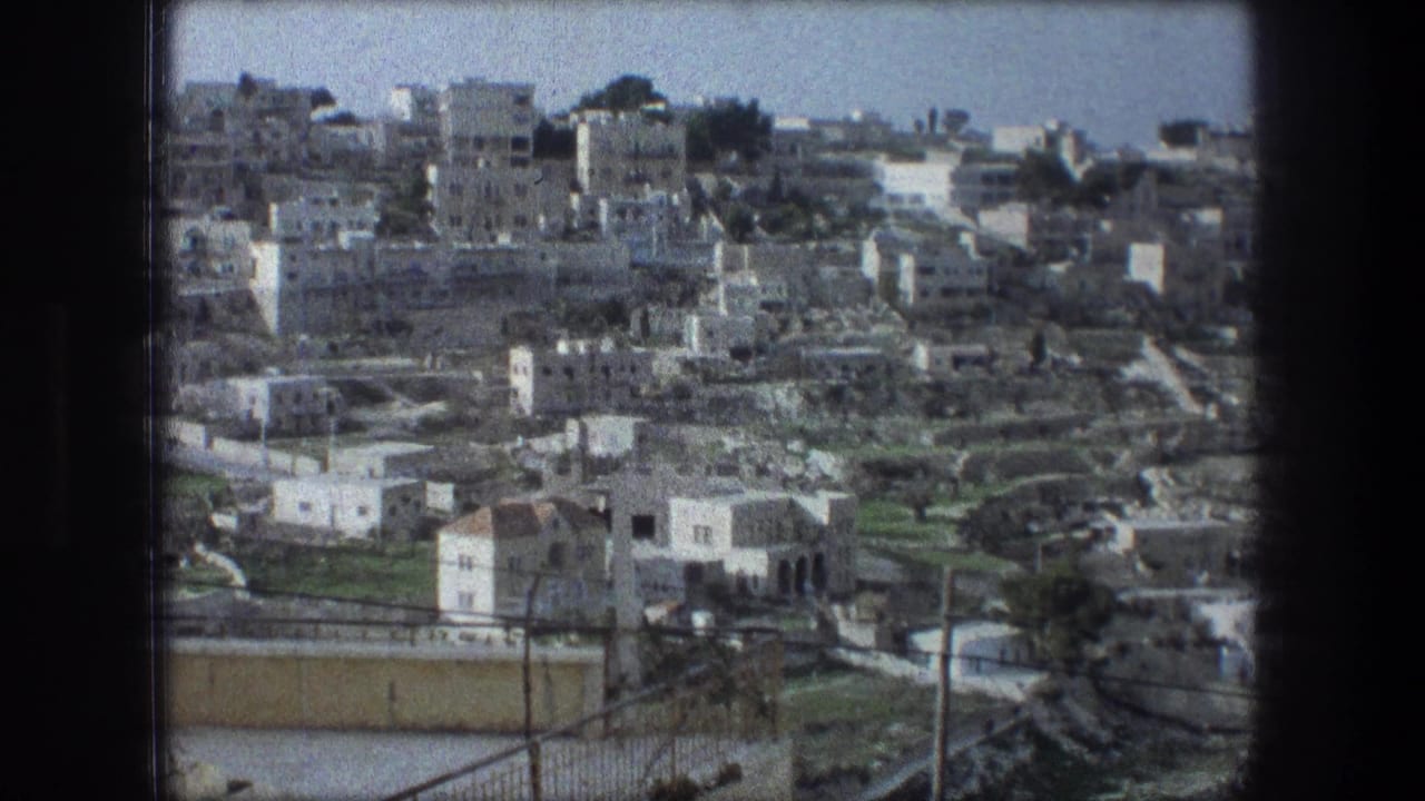 Wide 1976 Bethlehem town view on 8mm film, showing dense pale buildings across a hillside under a clear sky.