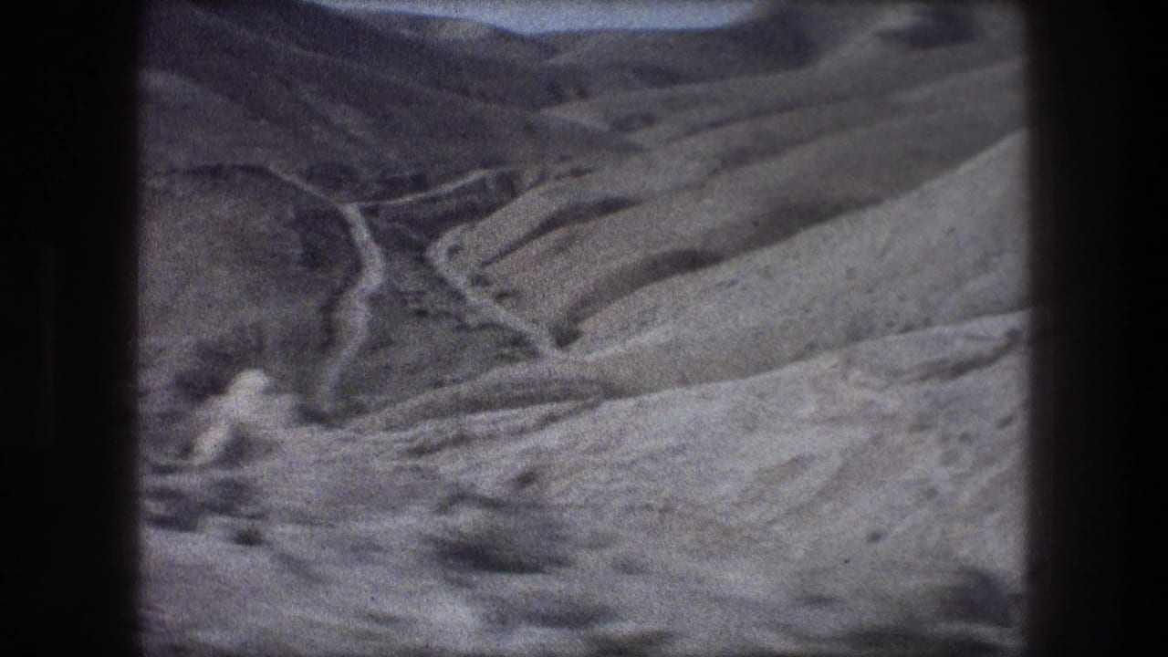 Bethlehem-area landscape on 8mm film, with layered hills and a light-toned ravine or streambed across the center.