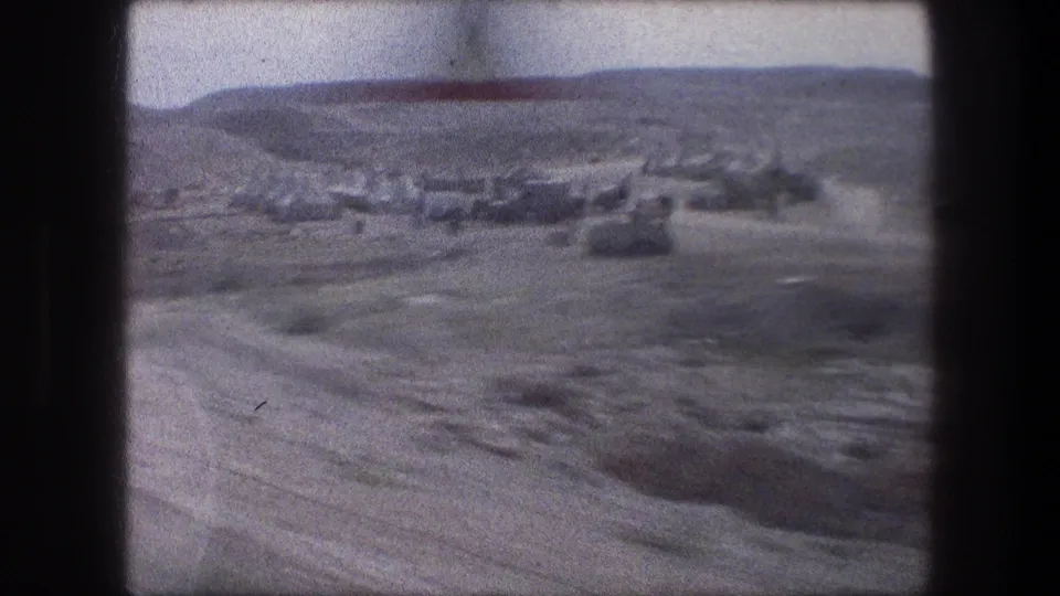 1976 Bethlehem-area view with distant structures, pale roads, dry hills, and open ground seen from transit.