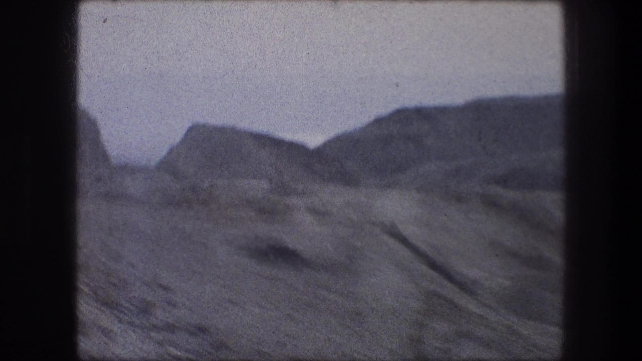 Bethlehem-area 8mm frame showing rugged mountain ridges and dry open ground, with motion softness and film grain.
