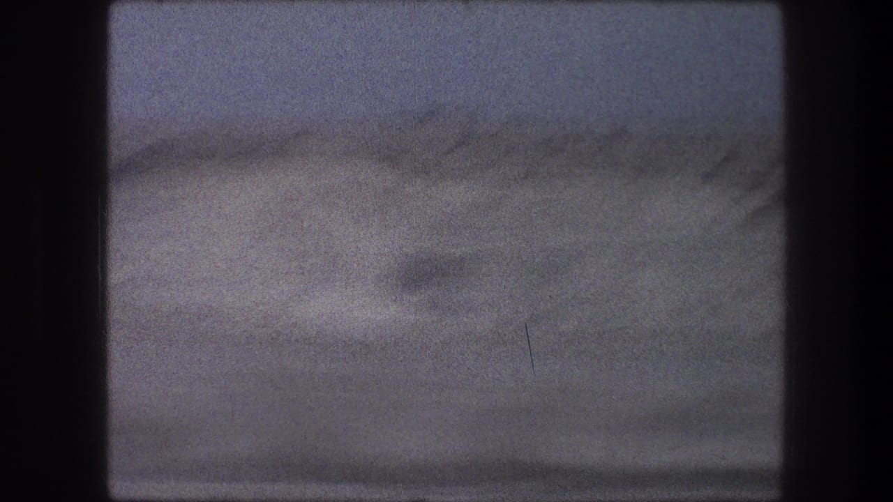 Soft 1976 8mm travel view of a sandy Bethlehem-area desert rise under a muted sky.