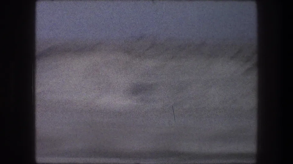 Soft 1976 8mm travel view of a sandy Bethlehem-area desert rise under a muted sky.