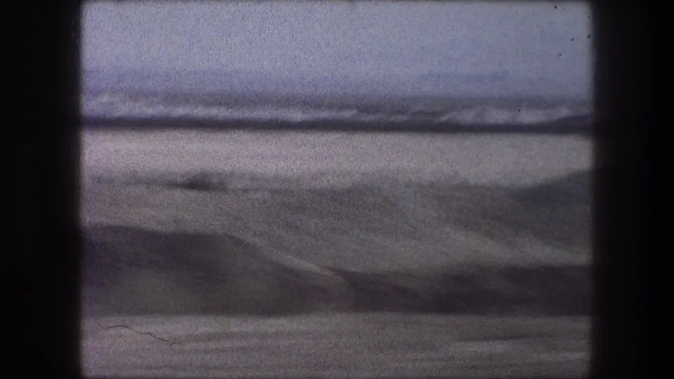 Soft 8mm frame of a blurred landscape passing outside a bus window during 1970s travel in Bethlehem, Israel.