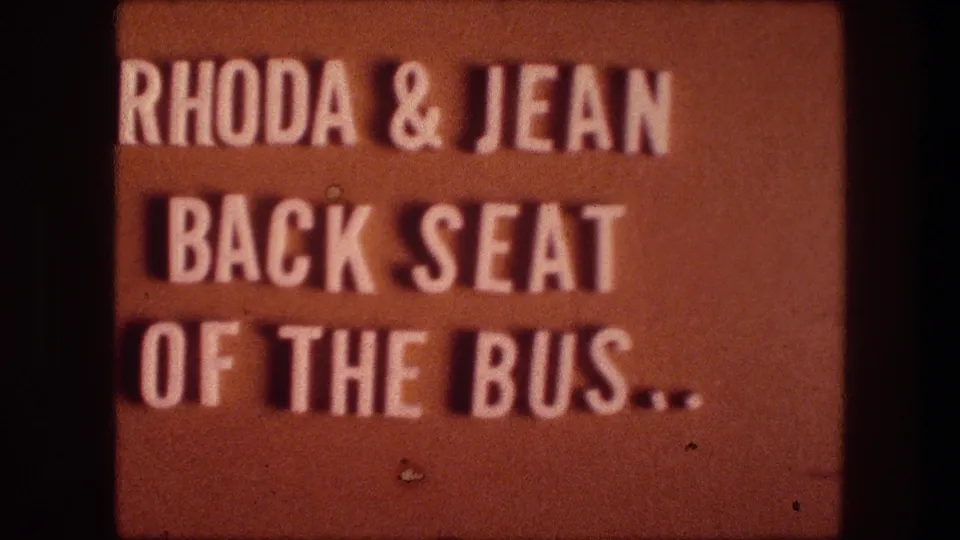 Second title-card frame repeating the Rhoda and Jean back seat of the bus text on an orange background.