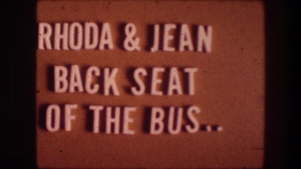 Orange 8mm title card with white text reading Rhoda and Jean back seat of the bus.