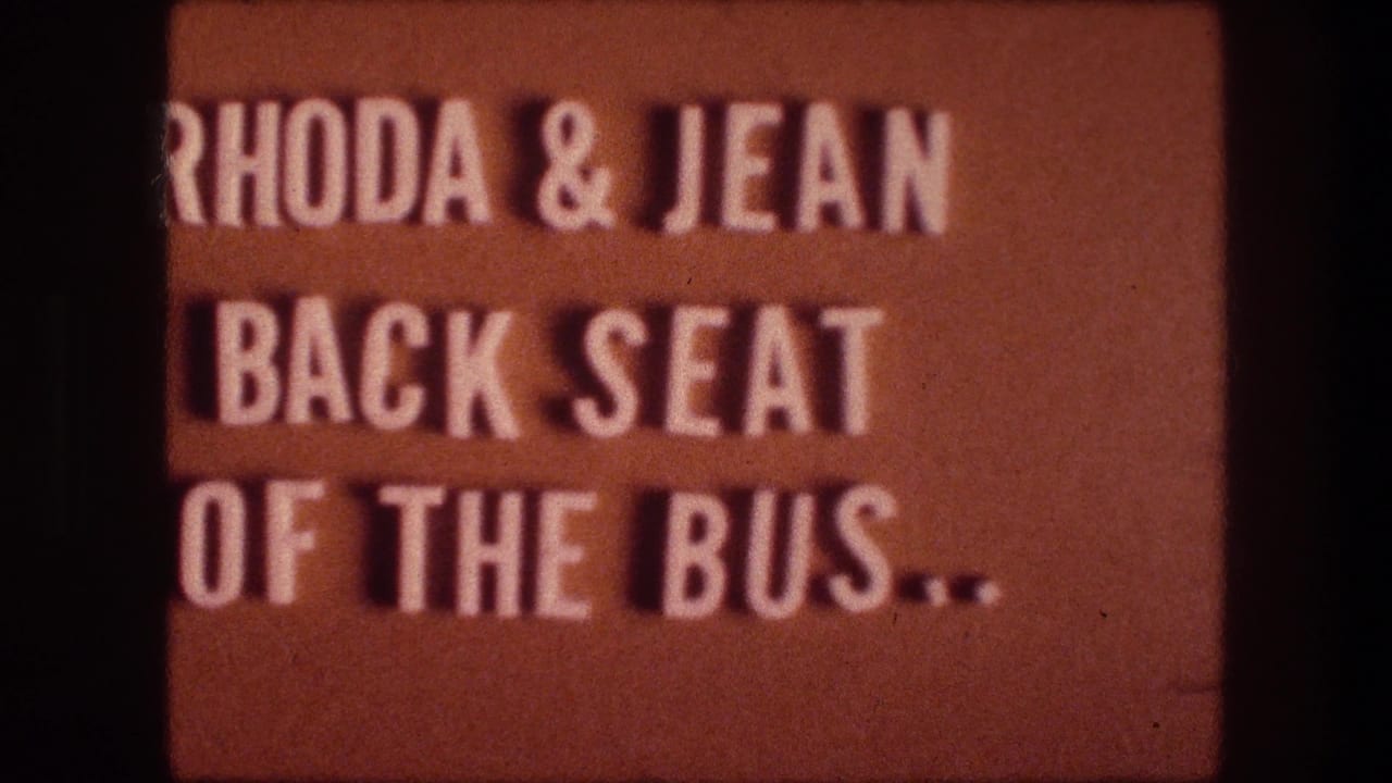 Orange title card with white lettering about Rhoda and Jean in the bus back seat.