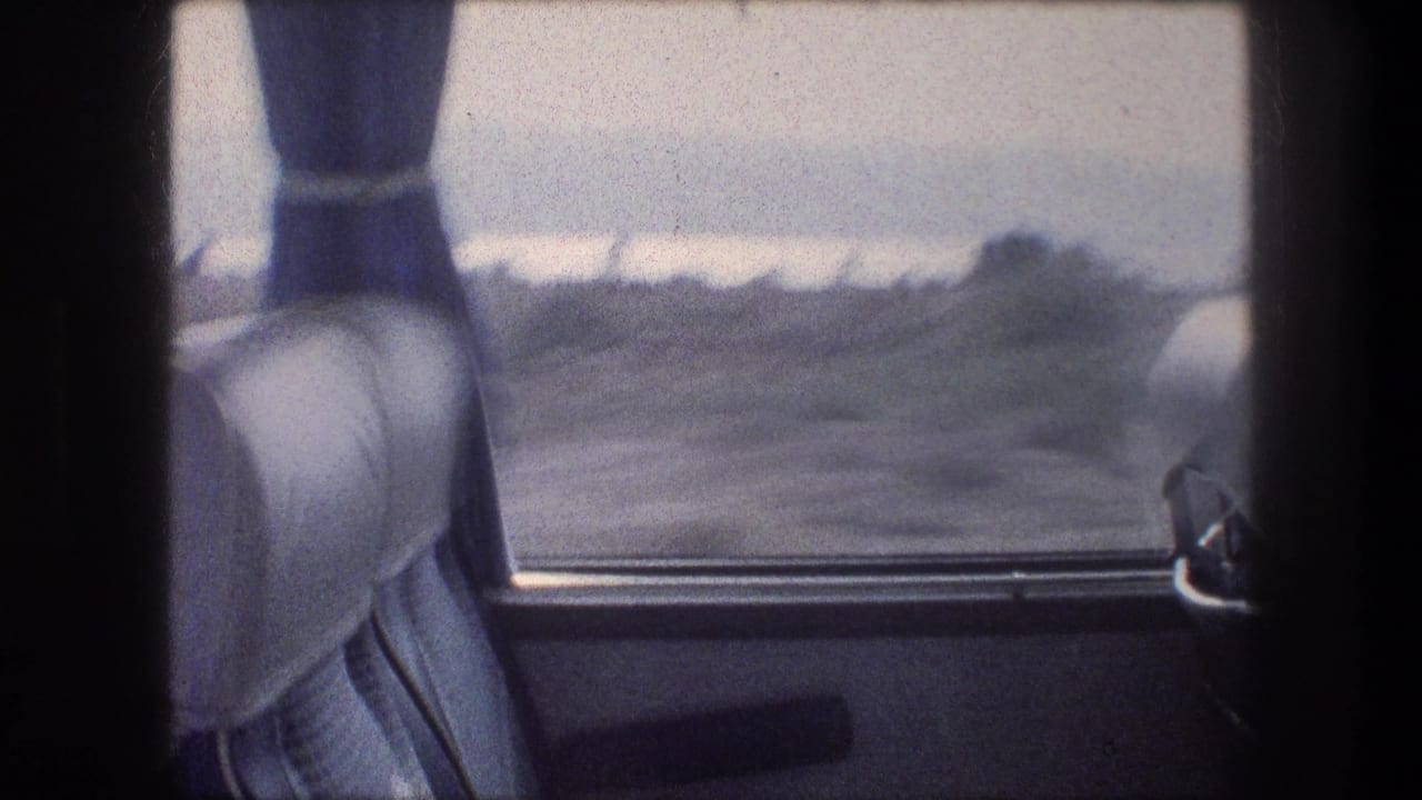 Interior bus view near Bethlehem, Israel, with upholstered seats, blue curtains, and dry terrain visible through the window.