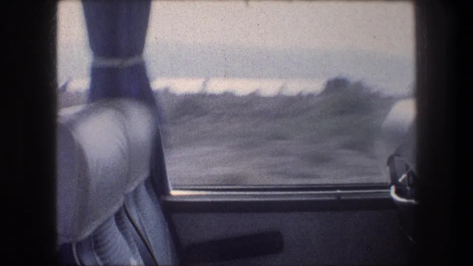 Interior bus view near Bethlehem, Israel, with upholstered seats, blue curtains, and dry terrain visible through the window.