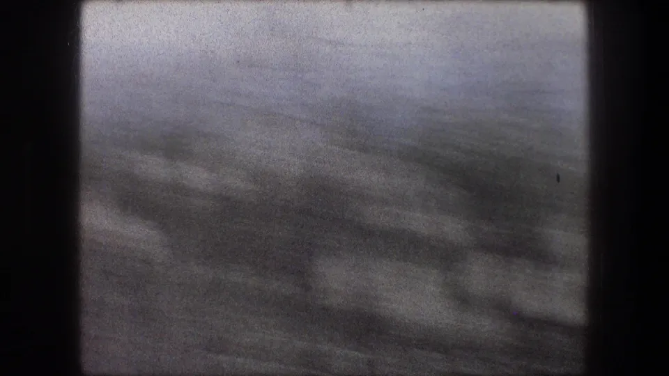 1976 Bethlehem travel footage frame with indistinct vegetation and horizon softened by rapid camera movement.
