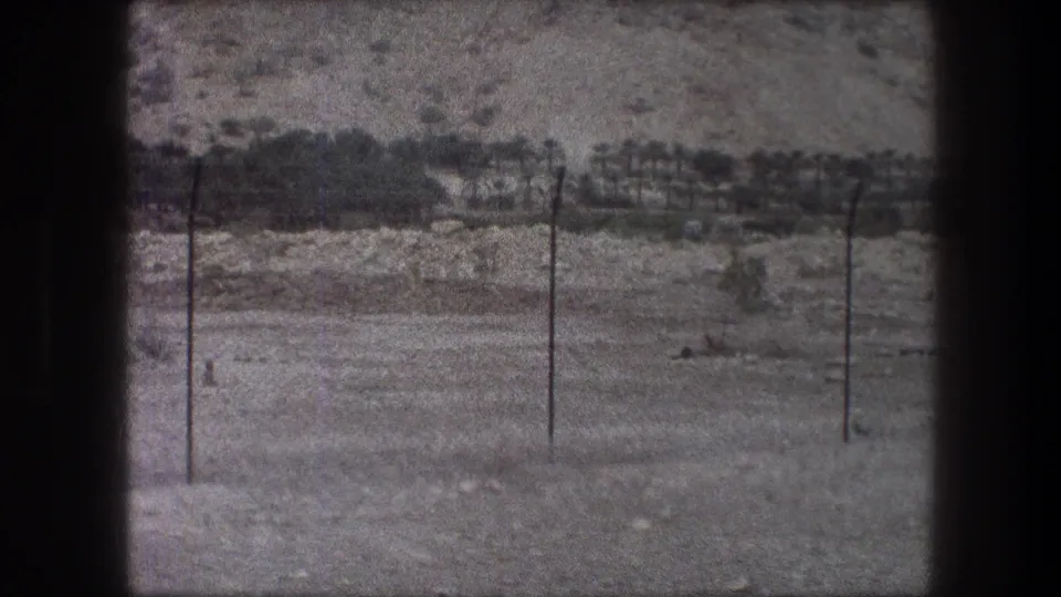 Bethlehem, Israel, 1976: two utility poles and faint wires cross a dry rocky landscape with low hillside vegetation in the background.