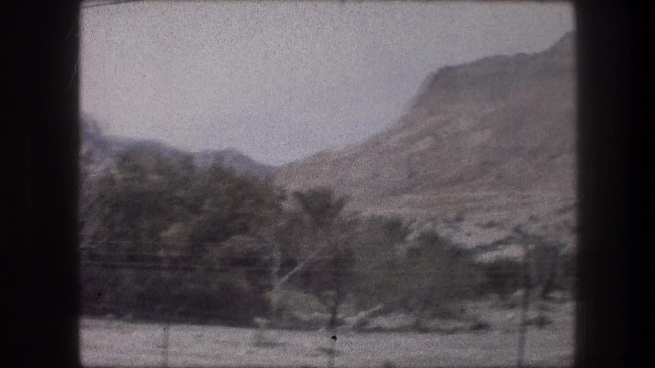 1976 Bethlehem-area landscape frame with tan hills, sparse trees, pale sky, and a diagonal power line crossing the view.