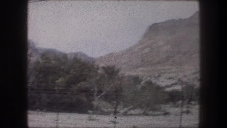 1976 Bethlehem-area landscape frame with tan hills, sparse trees, pale sky, and a diagonal power line crossing the view.