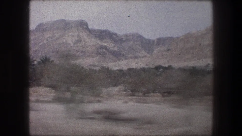 Bethlehem-area travel footage from 1976 shows rocky arid hills and scrub through a moving window view.