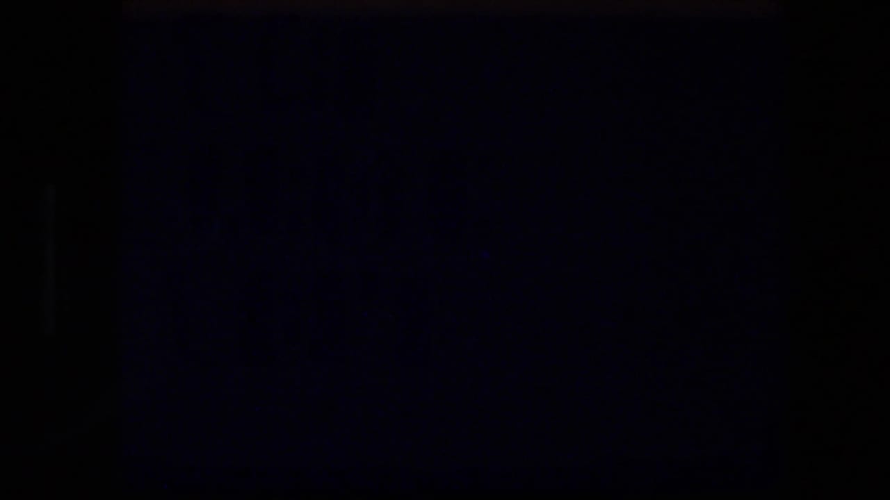 Dark transitional frame with little visible detail.