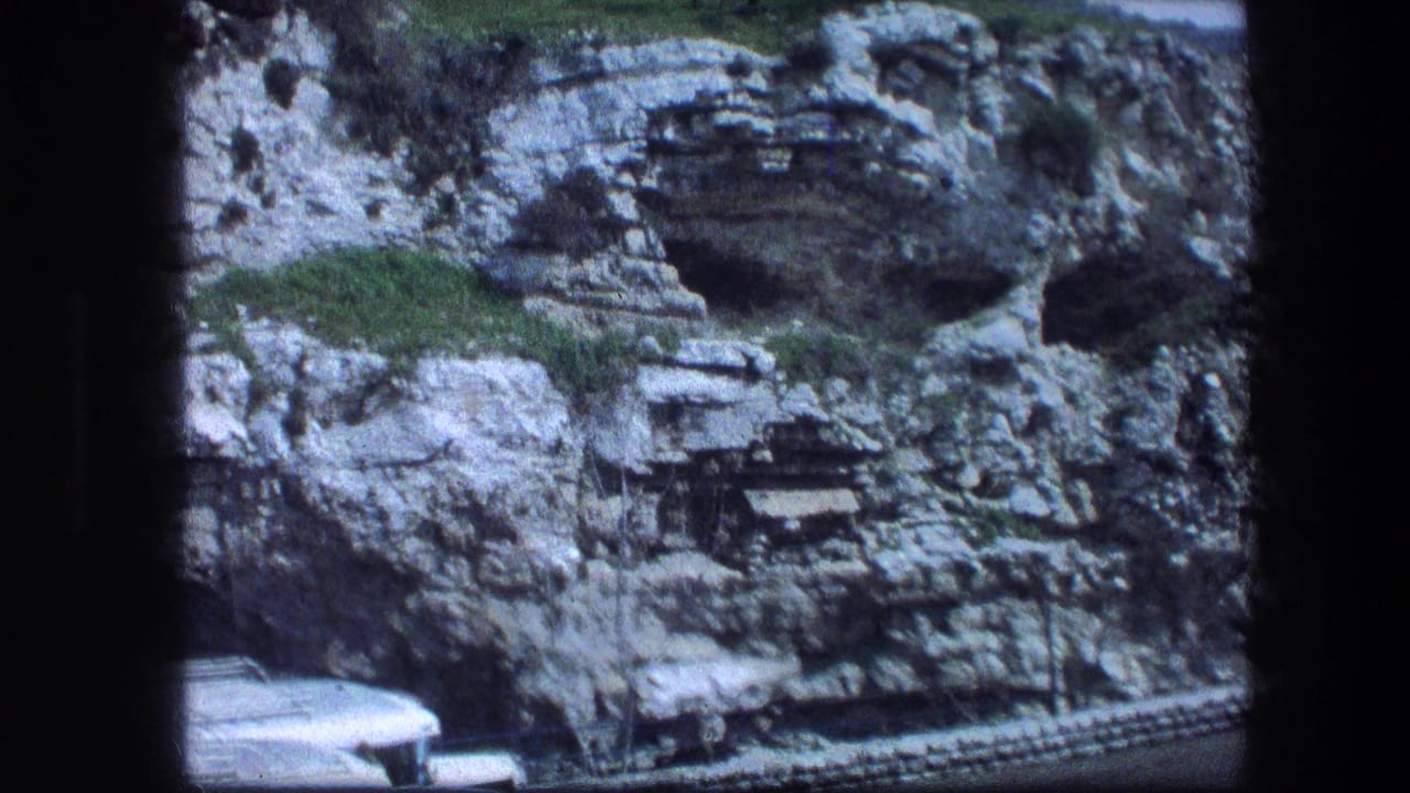 Garden Tomb area in Jerusalem, 1976, with the camera framing cave-like openings in the limestone hillside and a partial vehicle below.