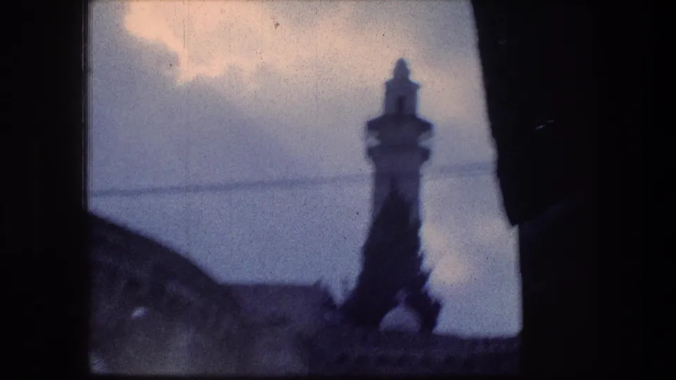 The camera briefly catches a soft, underexposed stone architectural detail at the Jerusalem site, framed by dark foreground edges.