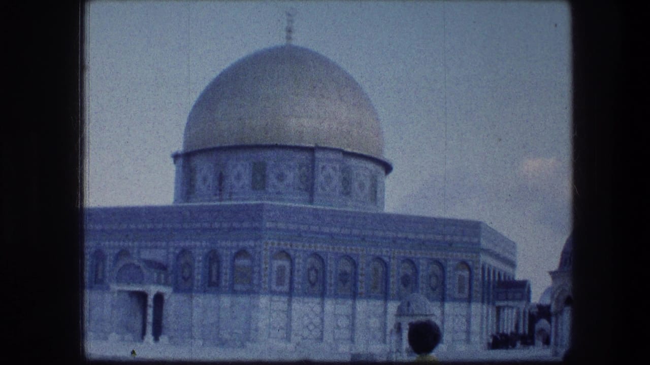 1976 8mm view of the Dome of the Rock in Jerusalem, with blue tilework and a quiet courtyard visible.