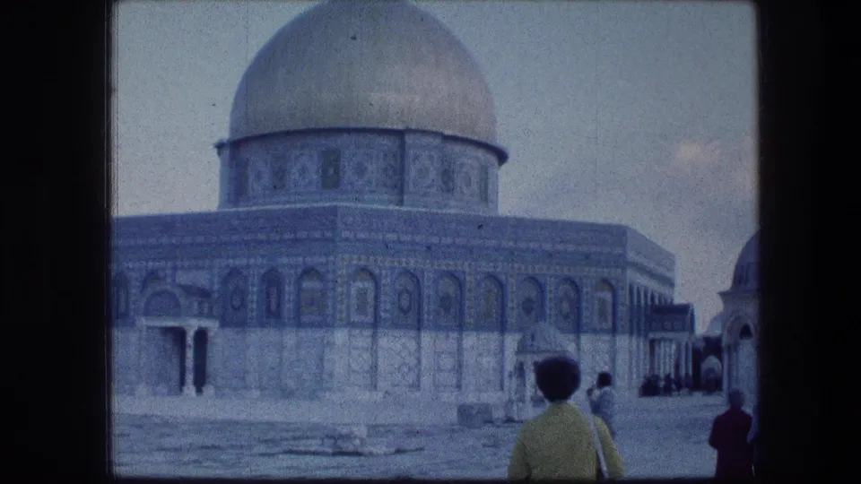 1976 Jerusalem home-movie frame showing the Dome of the Rock as visitors move across the courtyard.