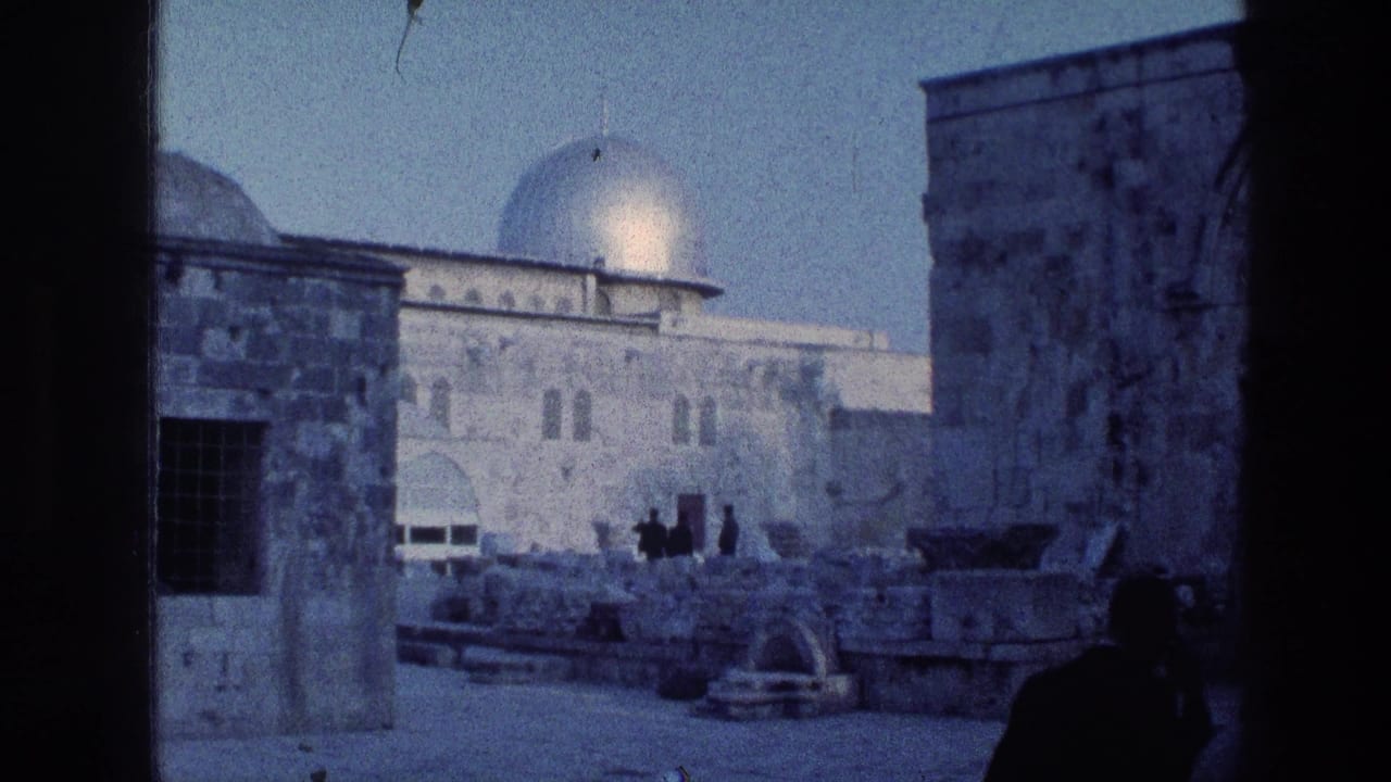 Dome of the Rock and stone courtyard seen through a dark foreground opening.