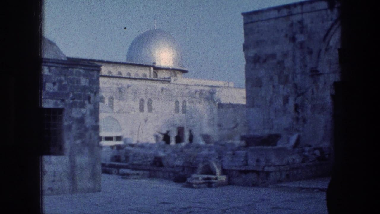 Stone courtyard with the Dome of the Rock visible behind foreground columns.