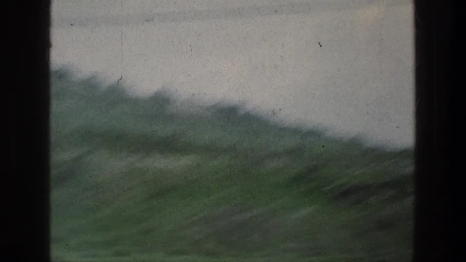 The final frame shows a soft, moving view of green hills and distant trees in the listed Jerusalem area on 8mm film.