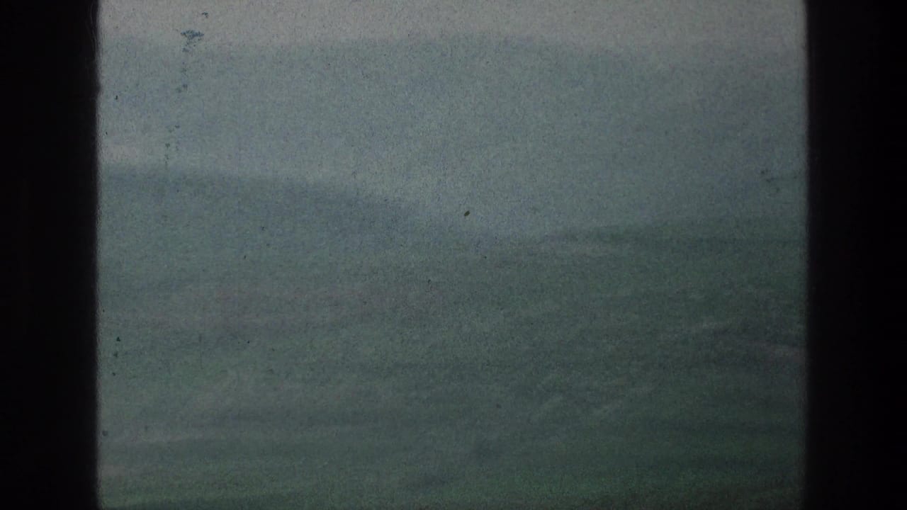 1976 8mm view of misty hills near the listed Jacobs Well Jerusalem, Israel location, framed by dark scan edges.